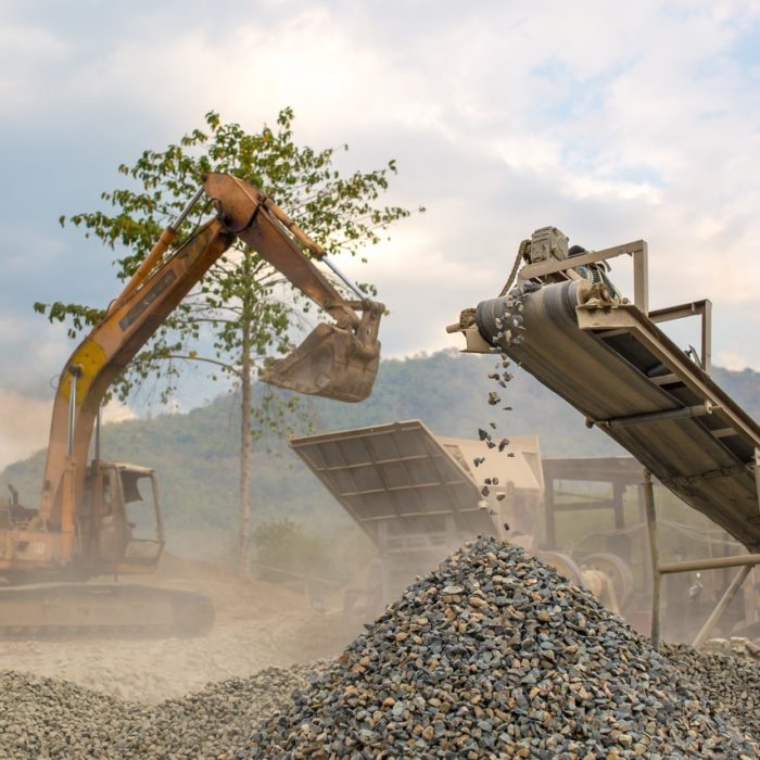 Heavy machinery such as excavator works at a quarry.