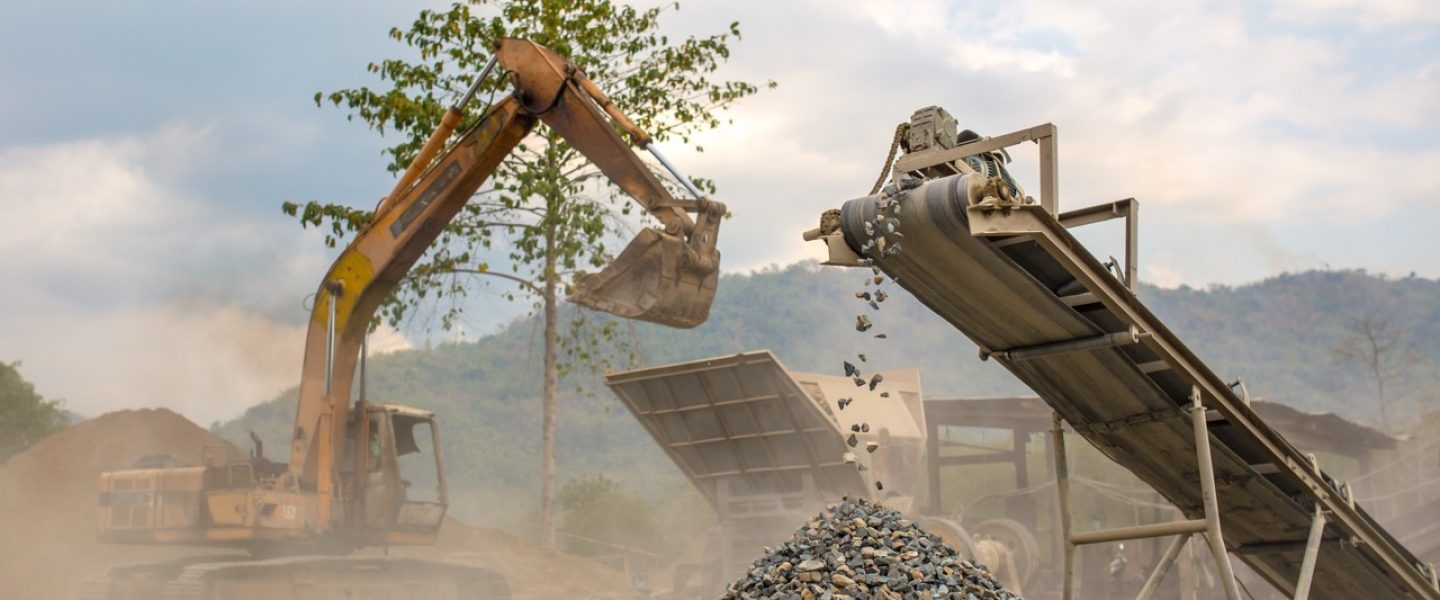 Heavy machinery such as excavator works at a quarry.