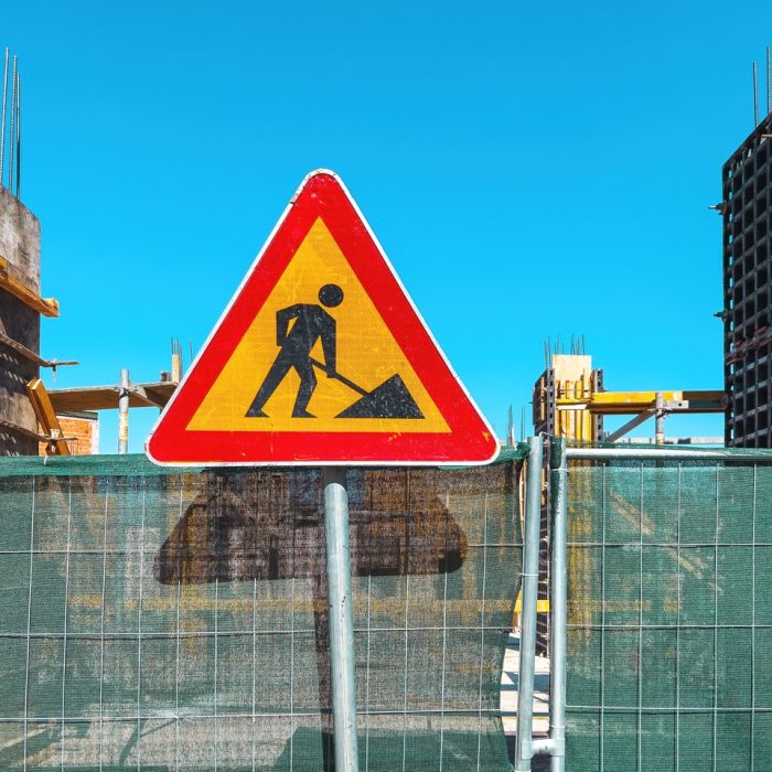 Road work traffic sign on construction site, A men at work warning signage
